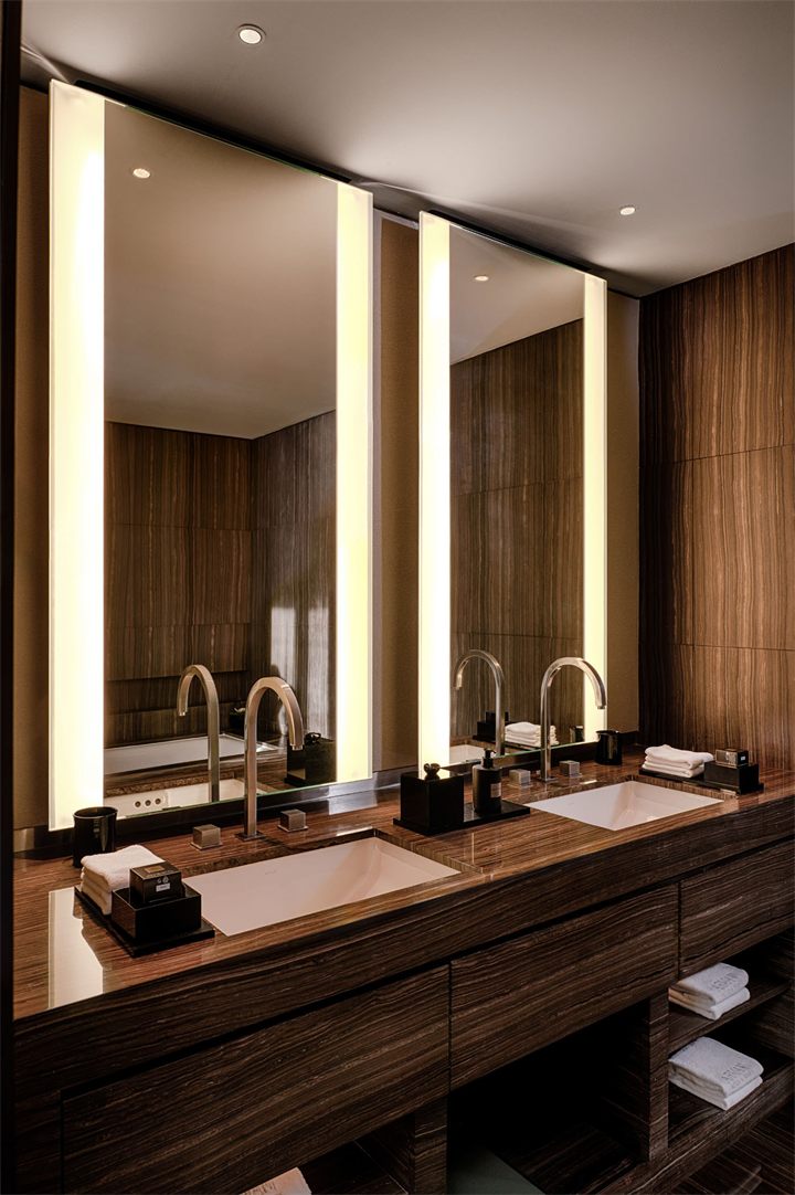 Hotel suite vanity with warm backlit mirrors